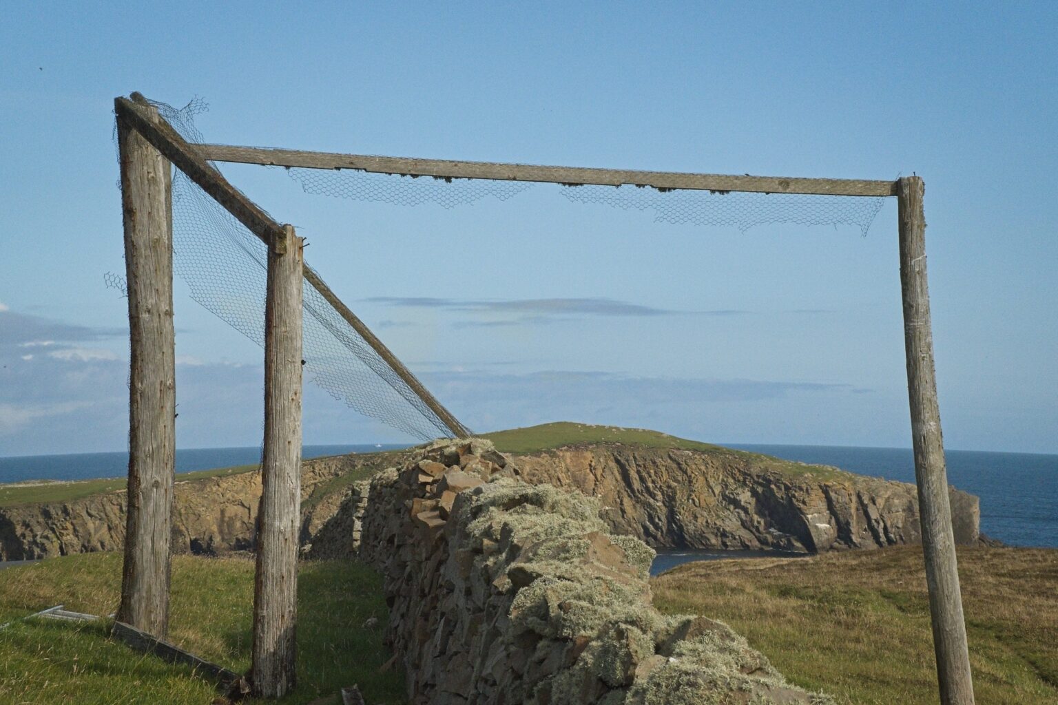 Detailed documentary study of a historic bird catching frame ruin, a traditional fowling structure unique to the remote heritage of Fair Isle