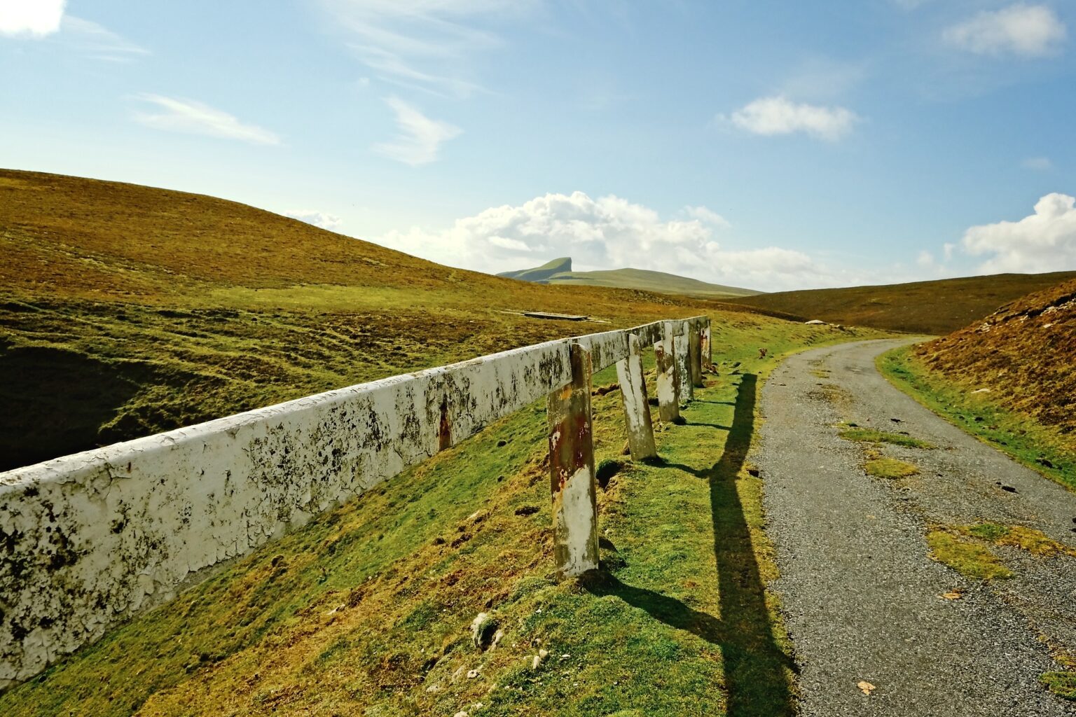 Observational landscape shot of a old crash barrier on a remote island road
