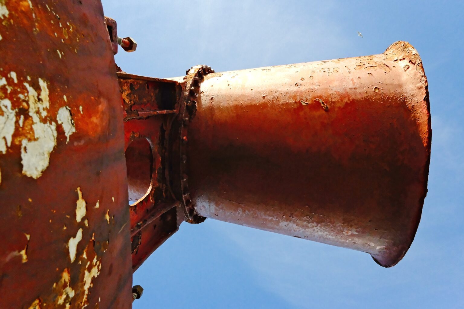 Editorial detail of a rusted industrial funnel, capturing the harsh maritime environment of the North Sea