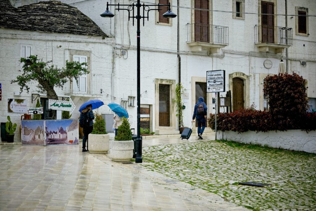 Observational shot of the textures and reflections on wet stone pavement during a rainstorm in historic Alberobello