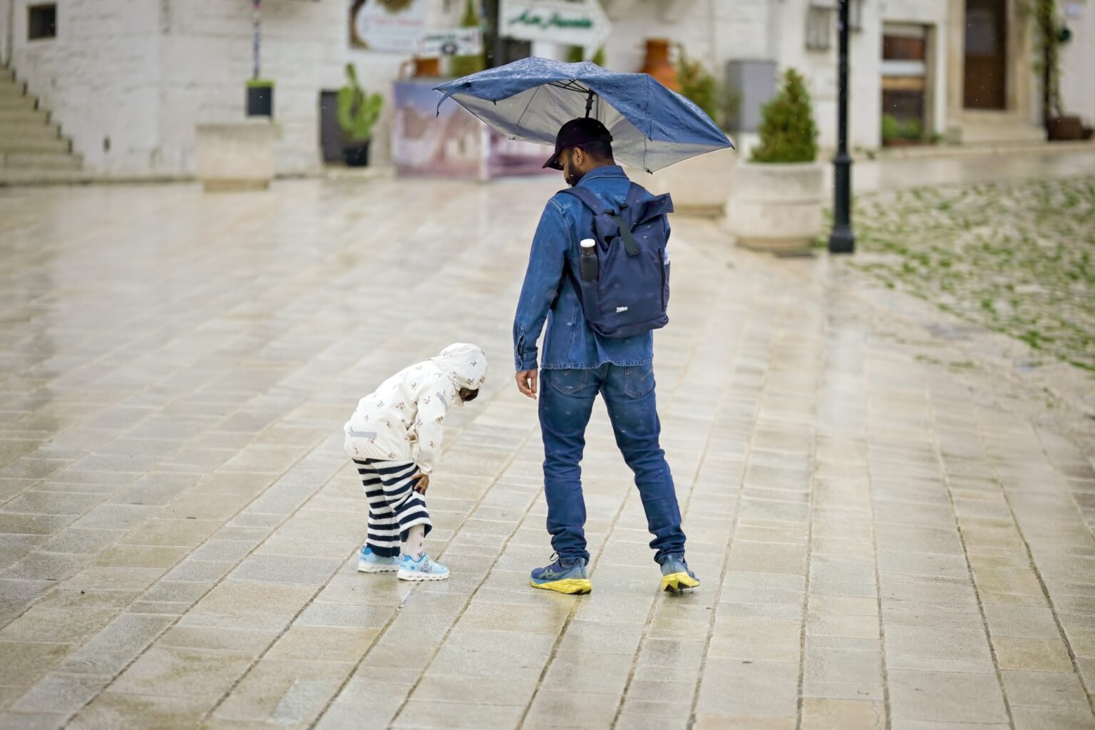 A touching, honest documentary moment of a father and child standing together in the rain