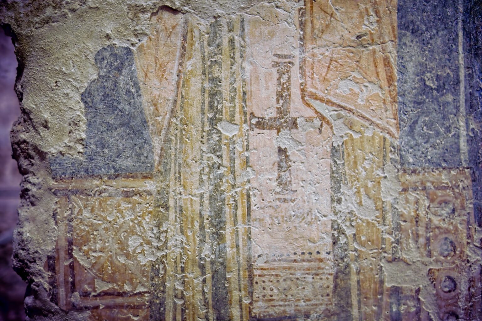 A minimalist texture study of a weathered ancient fresco on a stone wall, showing a faded cross and religious iconography in muted earth tones