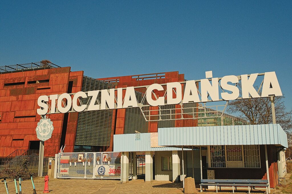 Wide-angle view of the historic Gate No. 2 at the Gdańsk Shipyard, the symbolic entrance to the birthplace of the Solidarity movement.