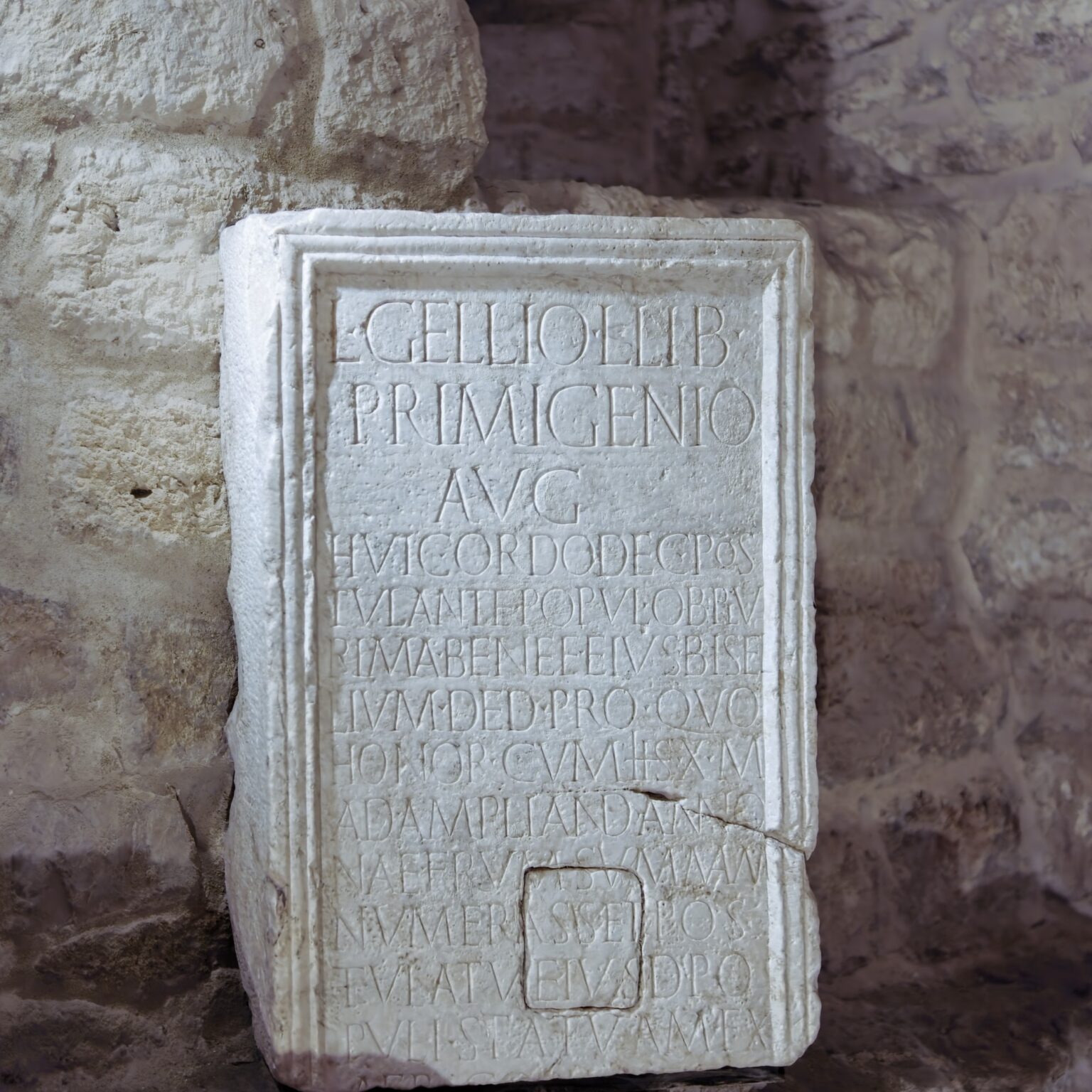 A minimalist texture study of an ancient Roman inscribed stone tablet of rememberance