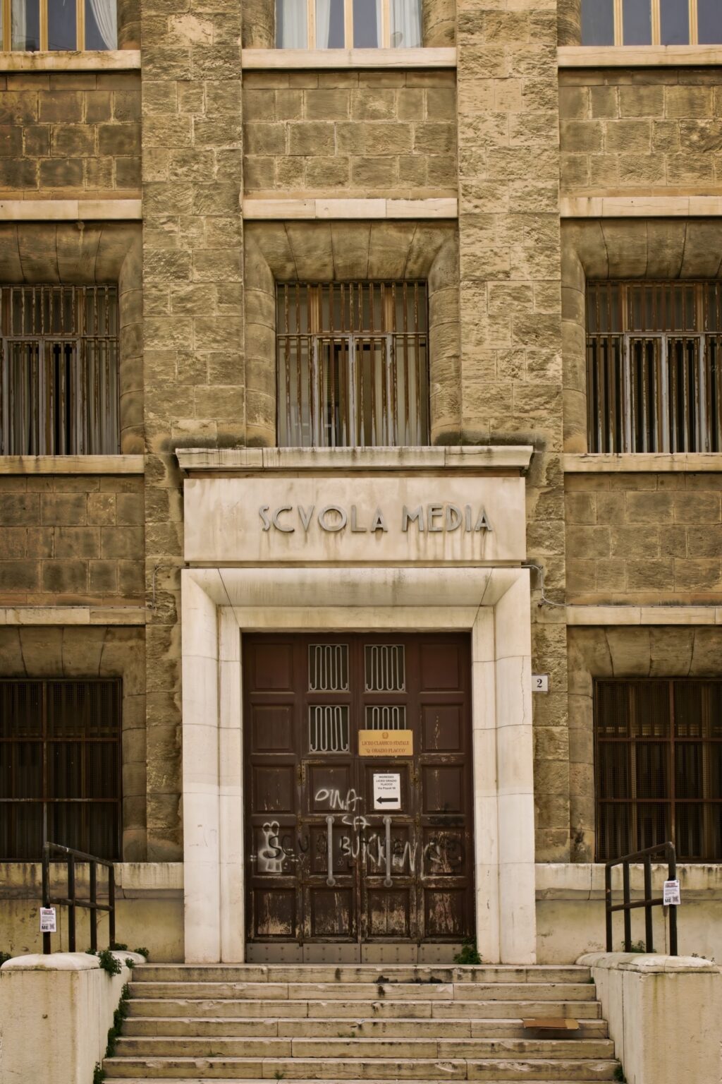 Architectural editorial shot of the stone entrance to the Scuola Media in Bari, captured by Guy Parker.