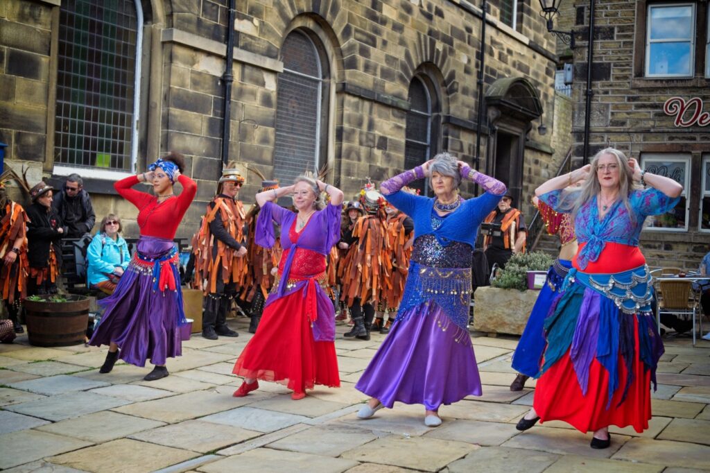Wide-angle documentary scene of the Holmfirth Festival of Folk in the Pennines
