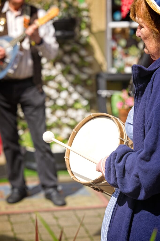 Atmospheric editorial street photography of the Holmfirth Festival of Folk musicians by Guy Parker.
