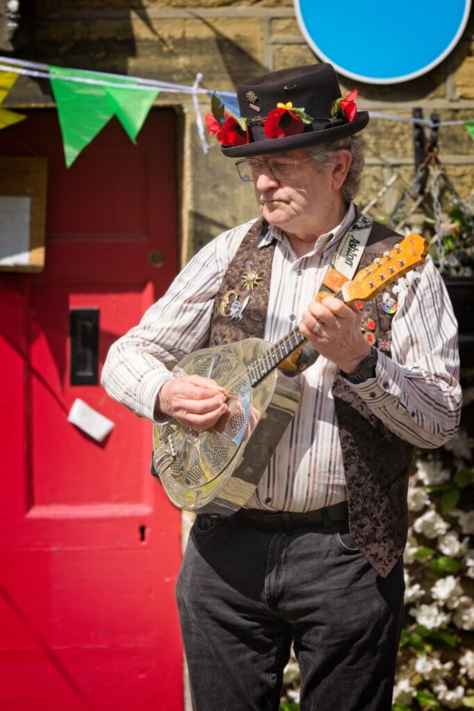 Editorial portrait of a folk musician at the Holmfirth Festival of Folk, captured in a documentary style