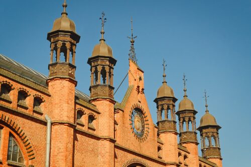 Close-up of the ornate gables and copper-topped turrets of the Great Armoury, a masterpiece of Dutch Mannerism in Gdańsk.